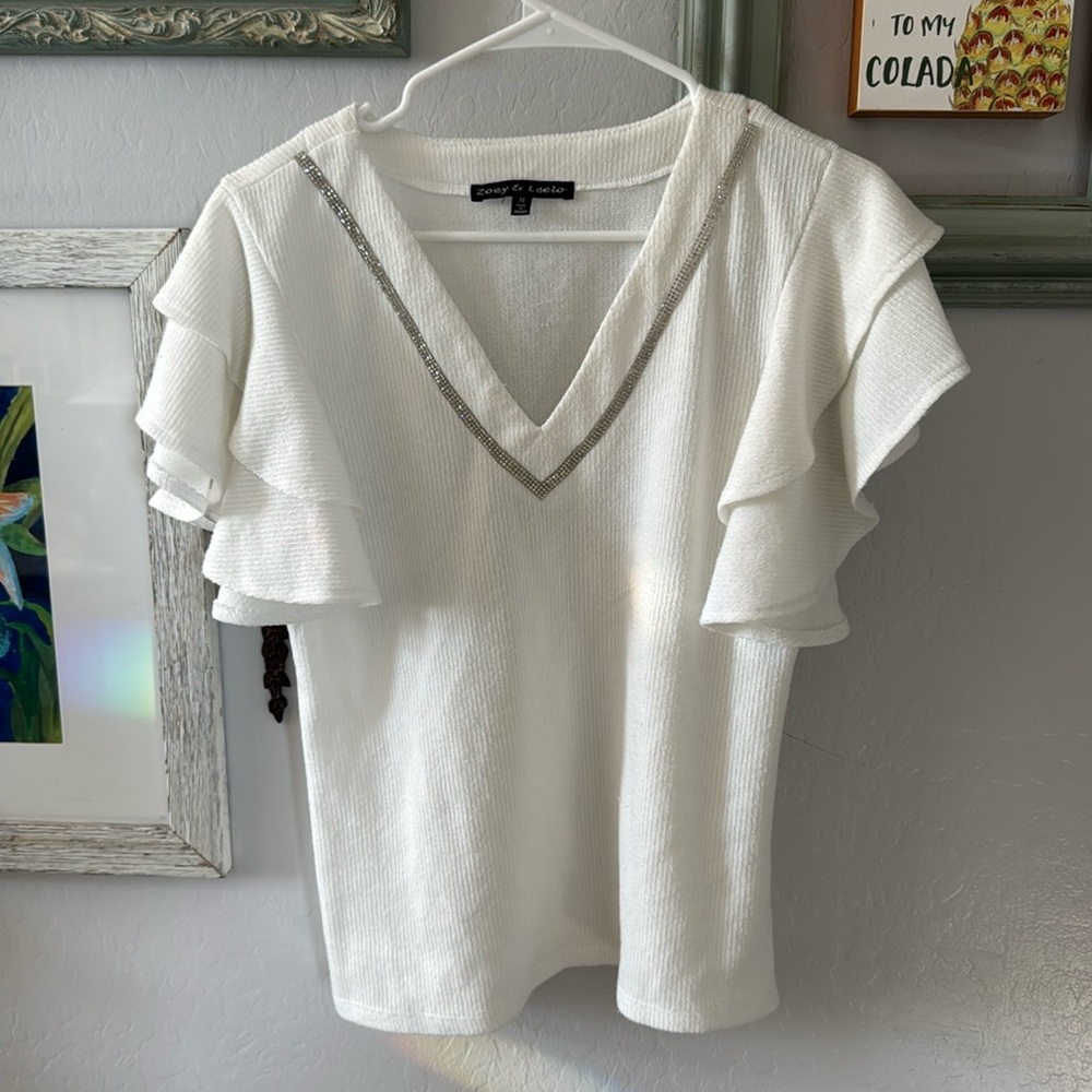 Cute flutter sleeve shoulder white dressy shirt Has a V neck with Diamond accent